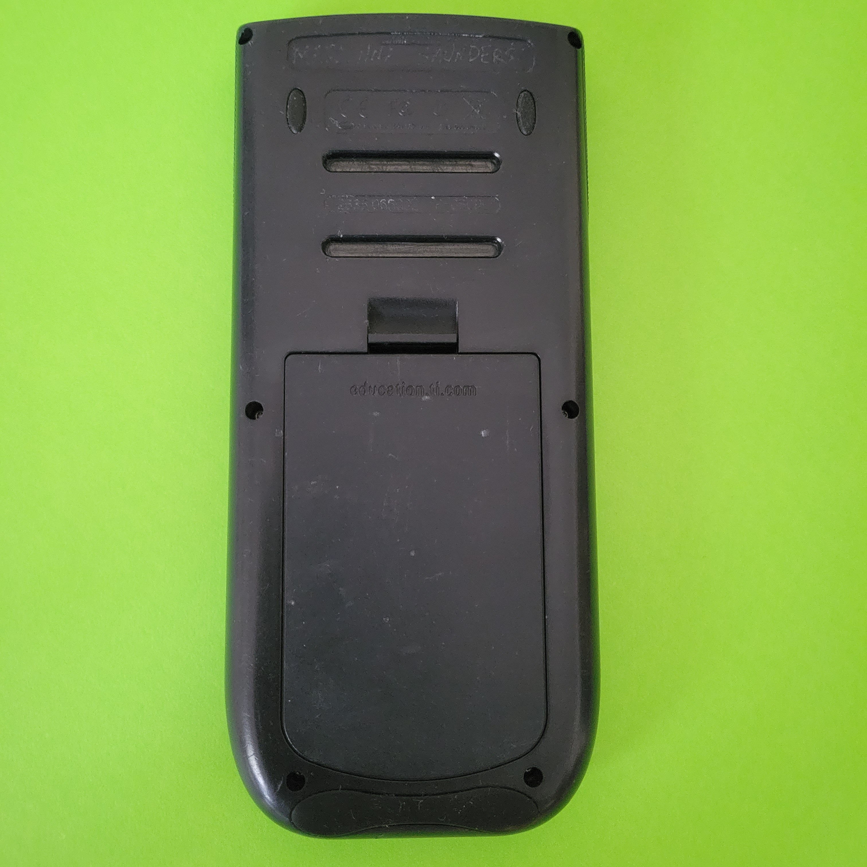 An image of the back of a Texas Instruments TI-84 plus graphing calculator